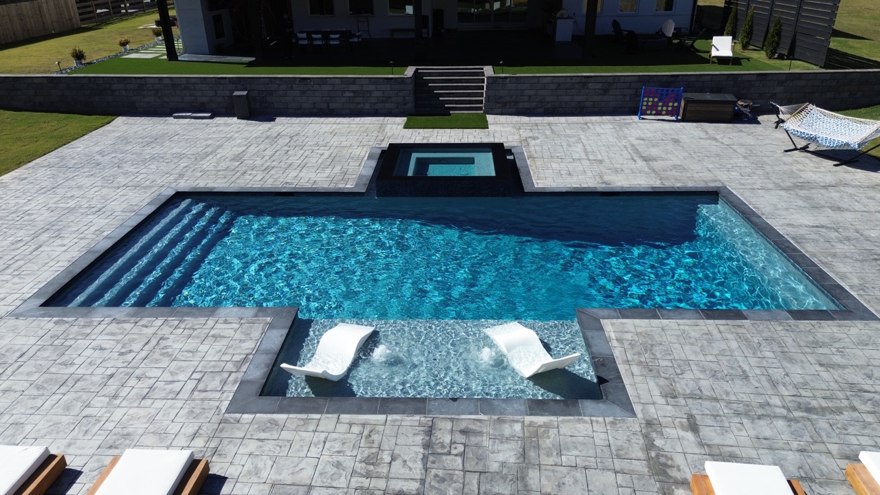 Luxury custom pool with spa and tanning ledge in Georgia backyard